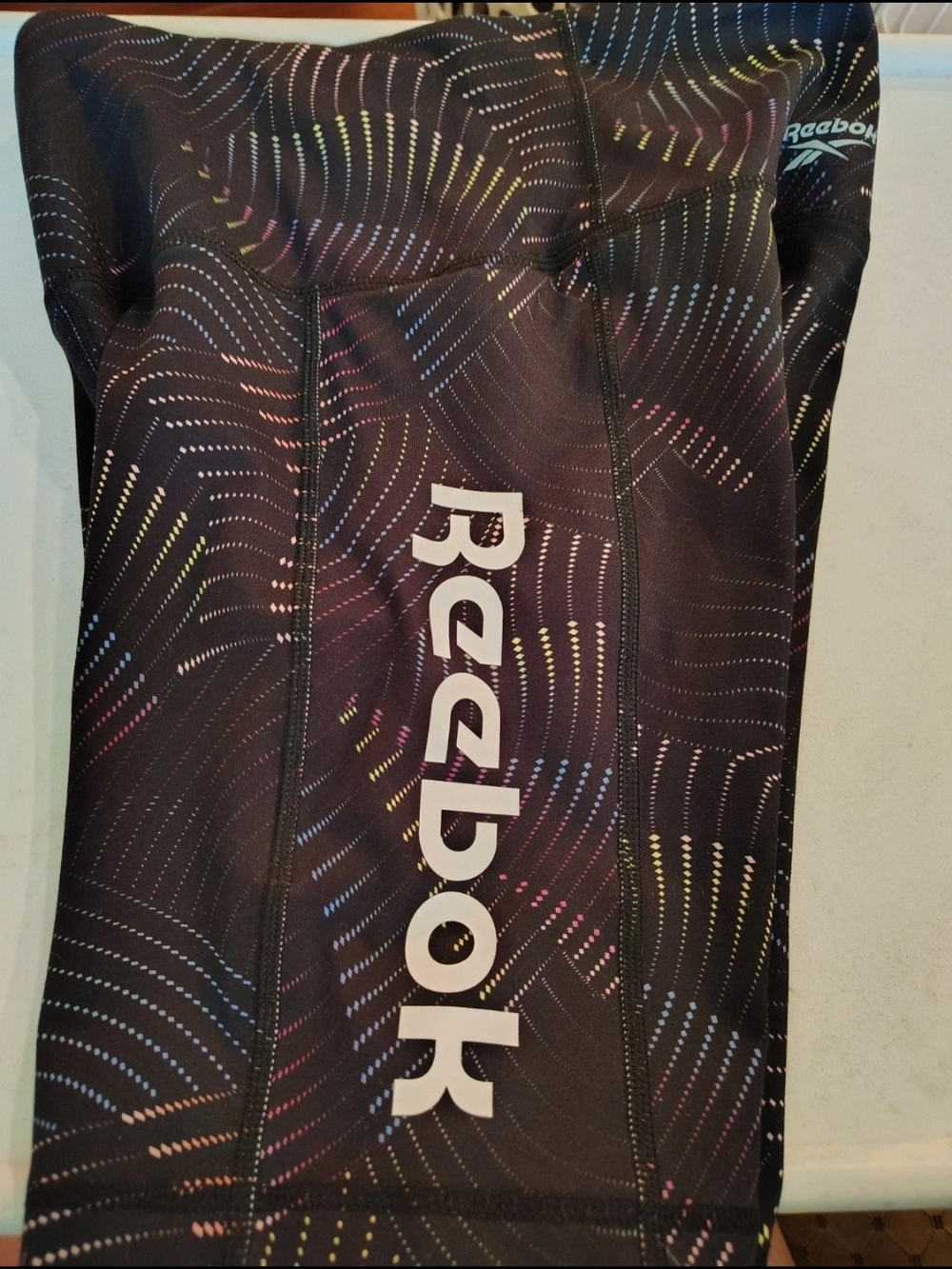 Reebok Kids One-Piece Athletic Suit in Black with Multi-Color Accent